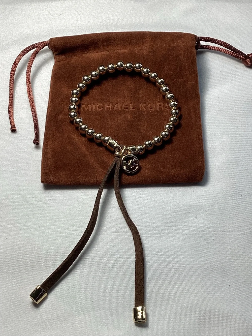 Michael Kors NWT and Dust Bag Gold-Tone Beaded Brown Suede Logo Charm Bracelet